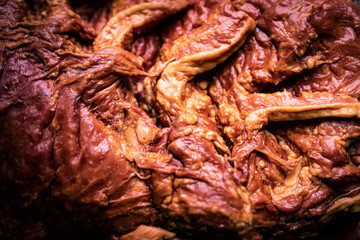 Freshly smoked, whole piece of bacon. Traditional, pork cold cuts, close up.