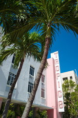 Naklejka premium Sunny view of classic Art Deco buildings with palm trees in Miami Beach, Florida, USA