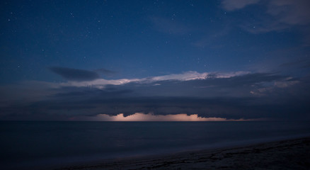 Gorgeous clouds on the horizon at the seaside with stars