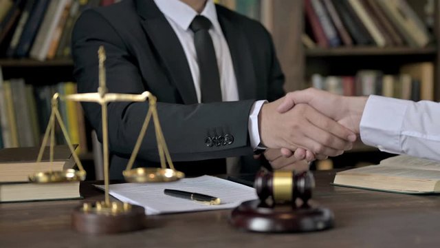 Close up Shoot of Judge Hand Shaking Hand on Office Table