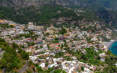 Fototapeta na wymiar Positano Panoramic View. Beautiful cliff view of Positano at daytime, with its colorful buildings. Amalfi coast situated in province of Salerno, in the region of Campania, Italy.