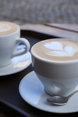 Hot cappuccino one cup with cookie on the wooden table ware