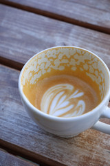 Hot cappuccino one cup with cookie on the wooden table ware