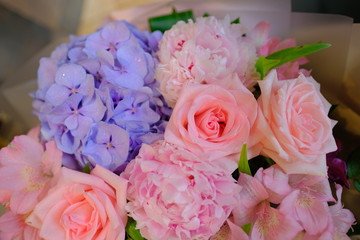 Macro view of colorful blue red green white pink orange purple rose flower bouquet in full blossom