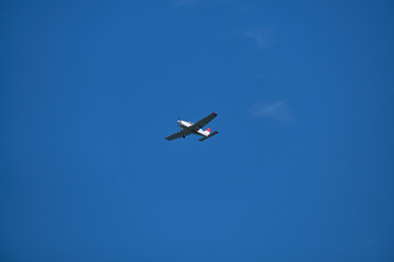 Fototapeta na wymiar Single engine plane in the blue sky, bottom view