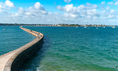 Fototapeta na wymiar panorama view of the long and winding stone harbor jetty in Saint-Malo