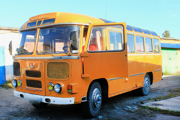old yellow bus in vintage style on a yellow background. Urban transport. Light vintage antique...