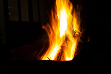 The fire burns in the grill at night. bright fire, wood. the flames on the night