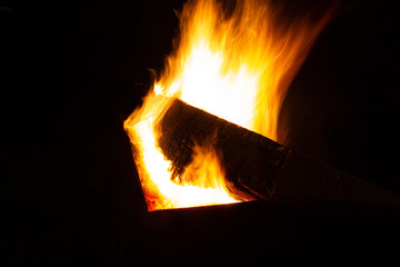 Fototapeta premium The fire burns in the grill at night. bright fire, wood. the flames on the night
