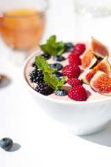 Smoothie bowl morning breakfast on the white bright sunny background. Close up