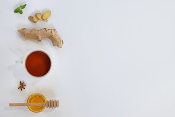 Ingredients for herbal ginger tea with honey, star anise and anise. Healthy food detox concept. Flat lay with space for text. Top view.