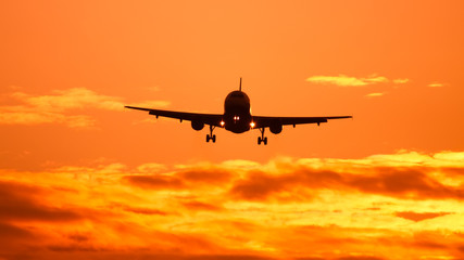 Fototapeta na wymiar air plane in sunset sky