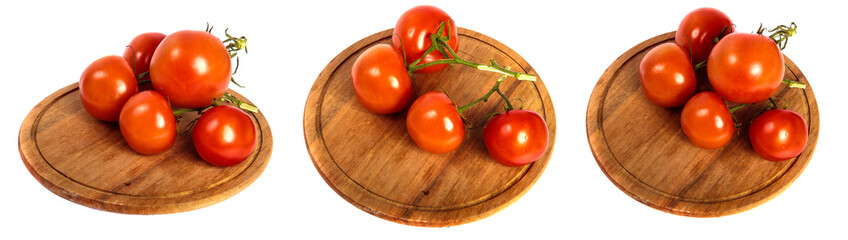 ripe red tomatoes on a round wooden cutting board. set