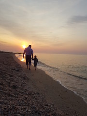 man walking on the beach at sunset