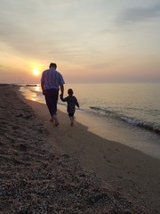 couple walking on the beach at sunset