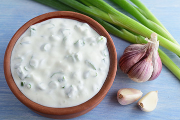 French Fromage Blanc Cheese with garlic and green onion in clay rustic pot
