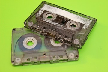 Old audio cassettes located on a green background