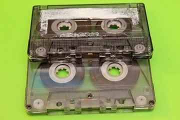 Naklejka premium Old audio cassettes located on a green background