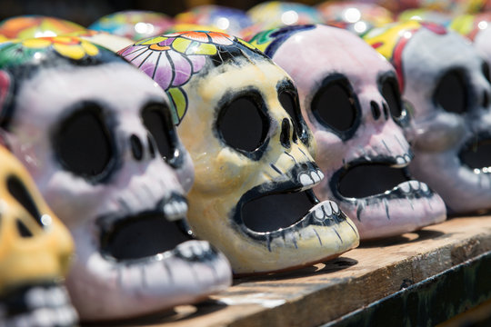 Mexican colorful skulls. Traditional Mexican souvenirs. The symbol of the holiday of the day of the dead. Ceramic pottery Day of the Dead, Dia de los Muertos, skulls.
