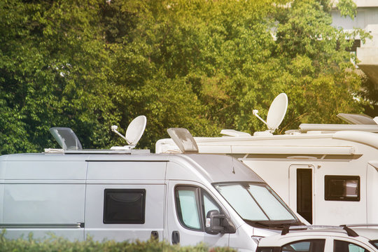 Satellite dishes on caravans. Electronic equipment on vans and campers for receiving video signals (copy space on the top of the image)