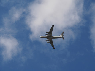 Plane in Sunny weather in the sky with clouds. Air transport closeup.