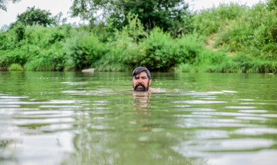 Swimming skills. Refreshing feeling. Man enjoy swimming in river or lake. Submerge into water. Freshness of wild nature. Summer vacation. Deep dangerous water. Relaxation and rest. Swimming sport
