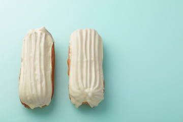Eclairs with White Chocolate Glaze on pastel  background