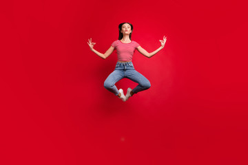 Full length body size photo of practicing girlfriend wearing jeans denim striped t-shirt while isolated over red background