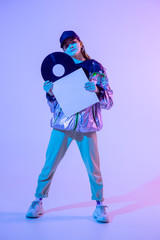 The girl with the vinyl record. Colored background and neon light. Modern clothes. Music poster....