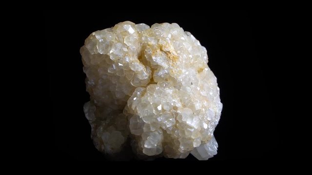 Macro shot of white crystal mineral, close-up footage with rotation. Isolated on black backround.