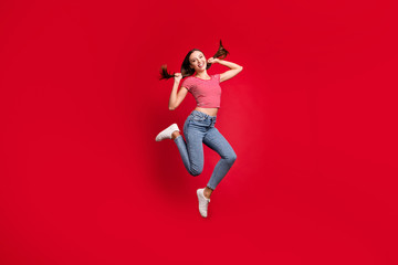 Full length body size photo of beautiful excited cheerful nice cute girlfriend playing her hair while isolated with red background