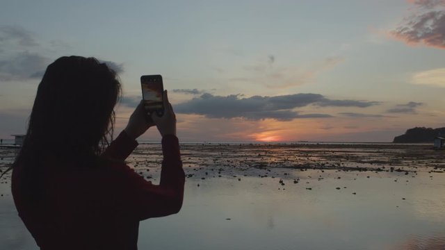 Back Shot Of A Millennial Girl Taking A Photo Of Sunset 4K