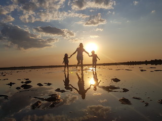 silhouette of woman on the beach at sunset