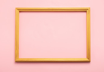 Golden square empty blank frame on pink background. Minimalism holiday concept. Flat lay. Copy space.