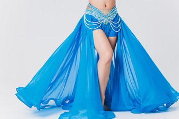 Portrait of belly dancer girl in blue. isolated on white.