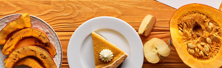 top view of pumpkin pie with apples on wooden table, panoramic shot