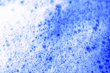 Beautiful abstract texture color white and blue bubbles background in water on blue background pattern clear soapy shiny