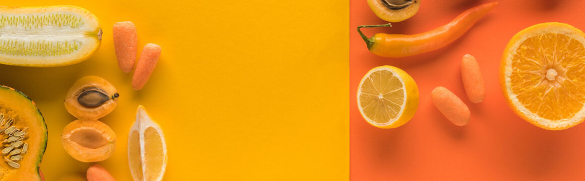 top view of yellow fruits and vegetables on orange background with copy space, panoramic shot © LIGHTFIELD STUDIOS