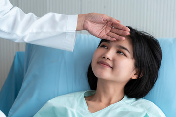 Fototapeta premium A doctor is taking care of a sick young woman with seasonal infections flu