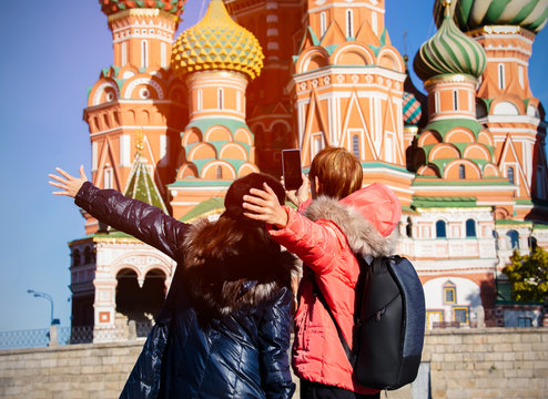Back view of Happy couple of tourists taking selfie in Moscow,Russia,Red square,view of St. Basil's Cathedral