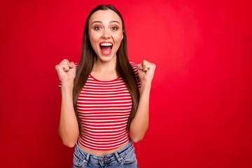 Photo of overjoyed rejoicing victorious girl shouting with having won something wearing jeans denim...