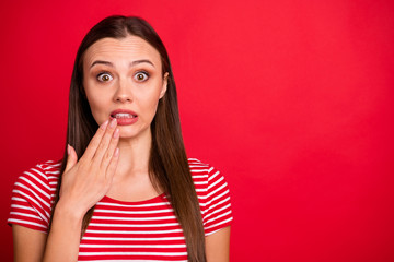 Close up photo of nice brunette charming beautiful shocked girl wearing striped t-shirt while isolated with red background