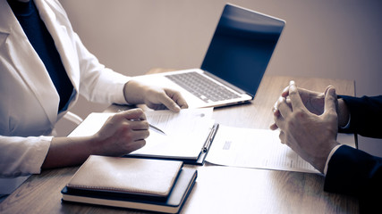 Employer or recruiter holding reading a resume with talking during about his profile of candidate, employer in suit is conducting a job interview, manager resource employment and recruitment concept