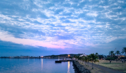Obraz premium Blue hour before sunrise in the harbour at Moiselle Bay's Ferry Terminal with the Maritime Museum in the background, Noumea, New Caledonia
