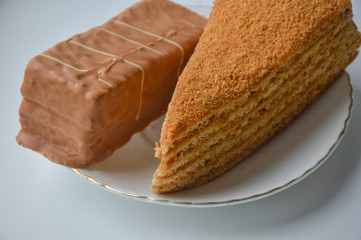 two delicious cakes on a white plate. candy.