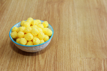 round yellow natural corn balls for breakfast in a ceramic plate