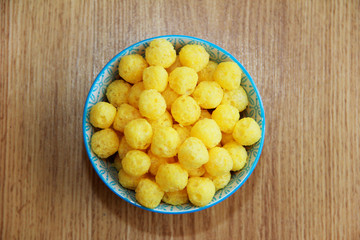 Naklejka na ściany i meble round yellow natural corn balls for breakfast in a ceramic plate