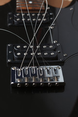 unstretched strings in an electric guitar bridge. Guitar with two humbuckers.