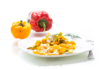 fried omelet from homemade eggs with sweet yellow pepper in a plate