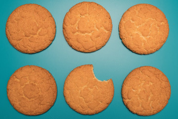 Cookies studio image. Homemade tasty cookies on a blue background. Bitten biscuits.